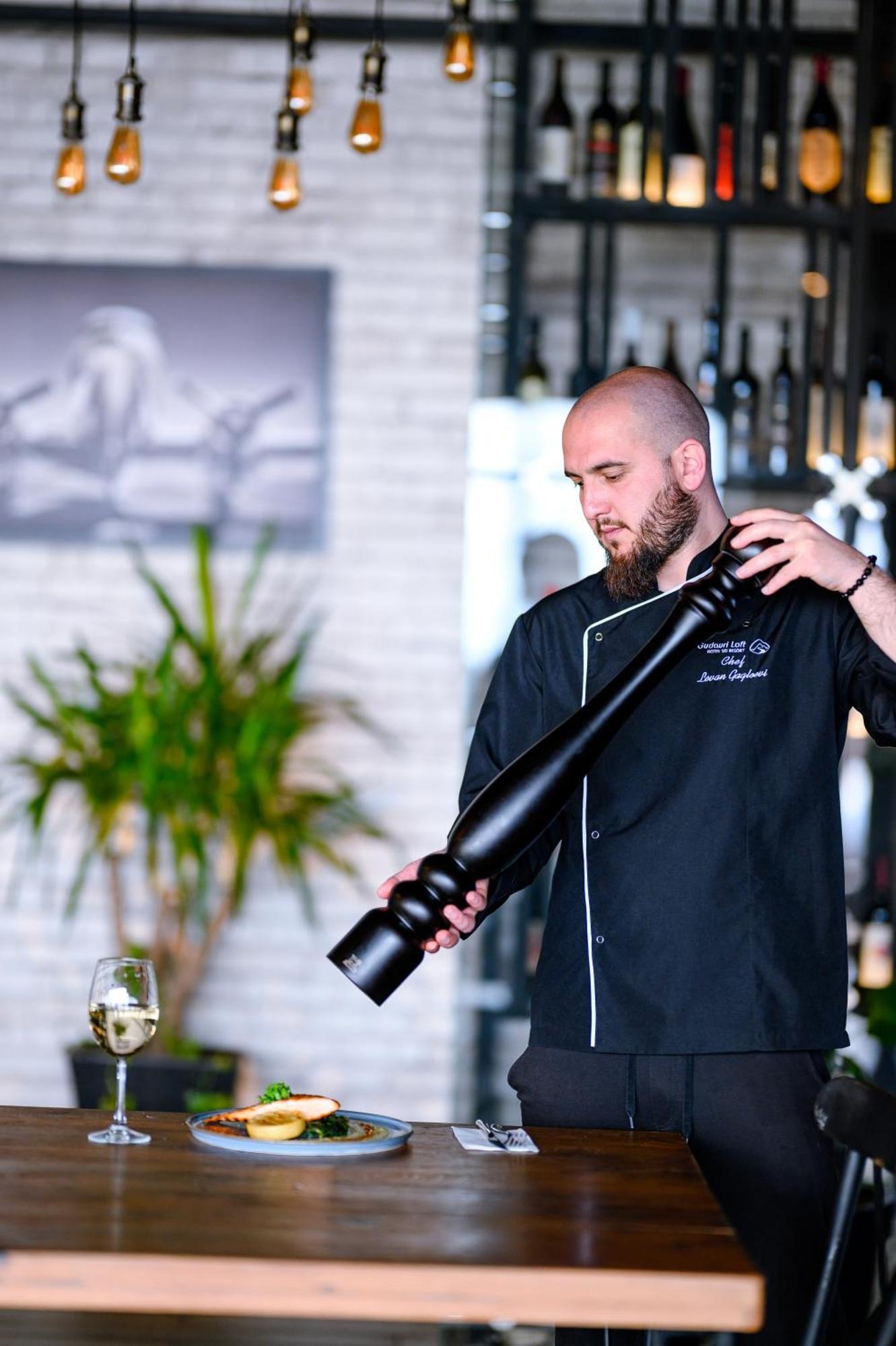 Gudauri Loft Hotel Exterior photo A chef using a pepper mill